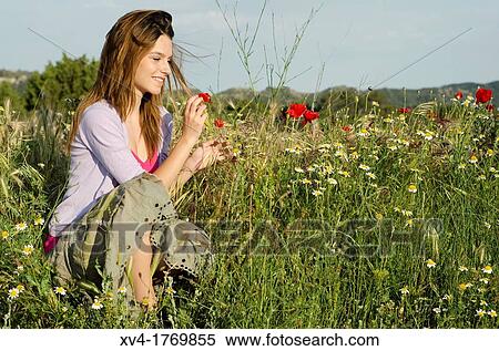 Brunette relaxing with poppy and enjoy in the countryside View Large Photo Image Stock Photography - Brunette relaxing with poppy and enjoy in the countryside. Fotosearch