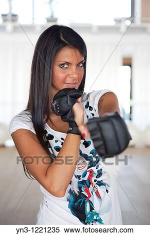 Brunette wearing black gloves for kick boxing training View Large Photo Image Stock Photography - Brunette wearing black gloves for kick boxing training. Fotosearch
