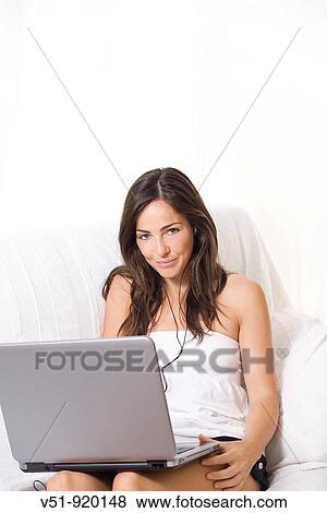 Brunette woman at home with laptop View Large Photo Image Stock Photo - Brunette woman at home with laptop. Fotosearch