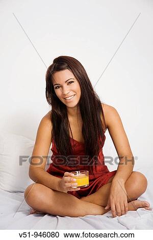 Brunette woman having an orange juice in bed View Large Photo Image Stock Image - Brunette woman having an orange juice in bed. Fotosearch