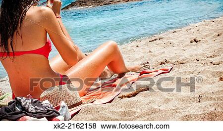 Brunette woman in bikini under the sun in a Menorcan blue beach View Large Photo Image Stock Photo - Brunette woman in bikini under the sun in a Menorcan blue beach. Fotosearch