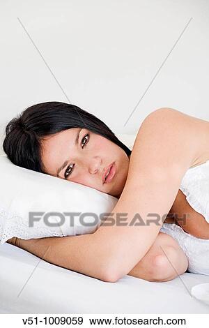 Brunette woman laying in bed seducing camera View Large Photo Image Stock Photo - Brunette woman laying in bed seducing camera. Fotosearch