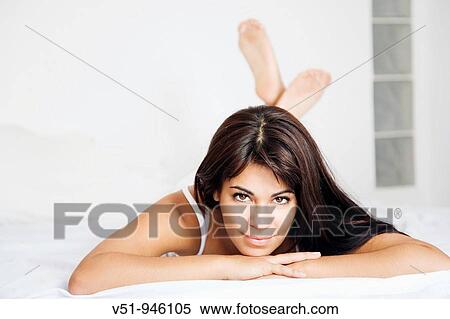 Brunette woman lying down in bed View Large Photo Image Stock Photography - Brunette woman lying down in bed. Fotosearch