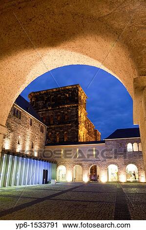 Stock Image - Brunnenhof with Porta Nigra, World Heritage Site, illuminated at night, Trier, Germany. Fotosearch