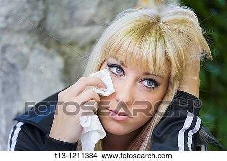 Brushing tears with a paper handkerchief View Large Photo Image Picture - Brushing tears with a paper handkerchief. Fotosearch