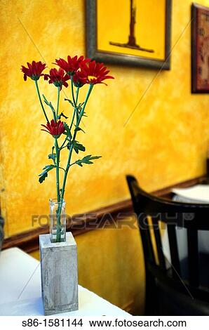 Picture - Bud Vase of Red Flowers on a Cafe Restaurant Table. Fotosearch