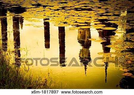 Stock Photo - Buddha statue and pool Wat Mahathat Sukhothai Historical Park Thailand. Fotosearch