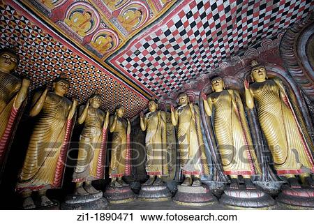 Stock Image - Buddha statues in the famous cave of Dambula, Sri Lanka. Fotosearch