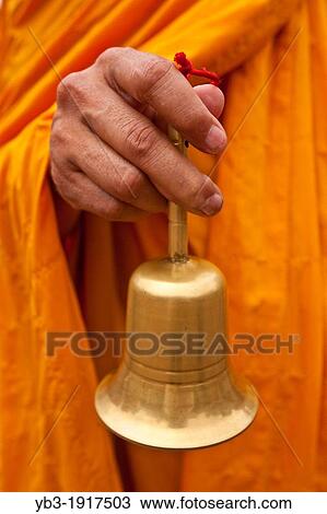 Stock Image - Buddhist Monk and Bell, Temple of Literature, Hanoi, Vietnam. Fotosearch