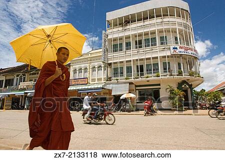 Buddhist monk walking down the streets of Battambang. View Large Photo Image Stock Photo - Buddhist monk walking down the streets of Battambang.. Fotosearch