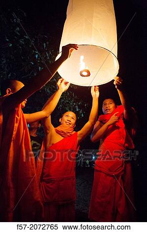 Buddhist monks lighting Chinese sky lanterns in Paske, Laos. View Large Photo Image Stock Photography - Buddhist monks lighting Chinese sky lanterns in Paske, Laos.. Fotosearch