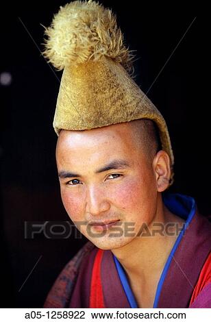 Stock Image - Buddhist Yellow hat Monk Labrang Monastery Xiahe Tibet China.. Fotosearch