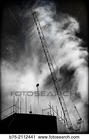 Building under construction with cranes working and a sky with clouds in the background. London, England, UK, Europe. View Large Photo Image Stock Image - Building under construction with cranes working and a sky with clouds in the background. London, England, UK, Europe.. Fotosearch
