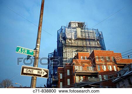 Building wrapped in scaffolding under construction View Large Photo Image Stock Image - Building wrapped in scaffolding under construction. Fotosearch