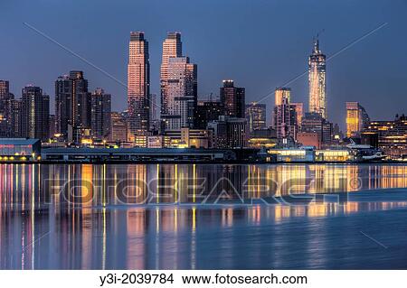 Buildings on the West Side of Manhattan, from approximately 54th Street to just south of the Intrepid Sea, Air and Space Museum, and their reflections on the Hudson River during the last hour before sunrise View Large Photo Image Picture - Buildings on the West Side of Manhattan, from approximately 54th Street to just south of the Intrepid Sea, Air and Space Museum, and their reflections on the Hudson River during the last hour before sunrise. Fotosearch