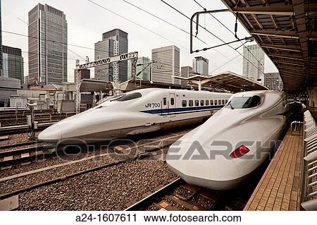 Stock Image - Bullet train at Tokyo Station and Marunouchi skyline, Tokyo, Japan. Fotosearch
