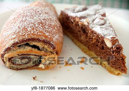 Bun and a piece of chocolate tart on plate View Large Photo Image Stock Photograph - Bun and a piece of chocolate tart on plate. Fotosearch