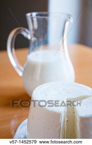 Burgos cheese and jug of milk View Large Photo Image Stock Photo - Burgos cheese and jug of milk. Fotosearch