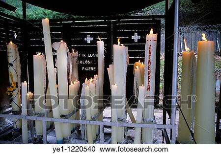 Stock Image - Burning candles dedicated to the Virgin Mary, Lourdes, France.. Fotosearch