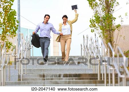 Business couple jumping stairs. San Sebastian Technology Park. Donostia. Gipuzkoa. Basque Country. Spain. View Large Photo Image Stock Image - Business couple jumping stairs. San Sebastian Technology Park. Donostia. Gipuzkoa. Basque Country. Spain.. Fotosearch