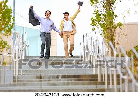 Business couple jumping stairs. San Sebastian Technology Park. Donostia. Gipuzkoa. Basque Country. Spain. View Large Photo Image Stock Photo - Business couple jumping stairs. San Sebastian Technology Park. Donostia. Gipuzkoa. Basque Country. Spain.. Fotosearch
