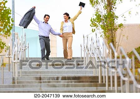 Business couple jumping stairs. San Sebastian Technology Park. Donostia. Gipuzkoa. Basque Country. Spain. View Large Photo Image Stock Photo - Business couple jumping stairs. San Sebastian Technology Park. Donostia. Gipuzkoa. Basque Country. Spain.. Fotosearch