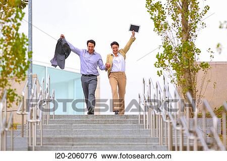 Business couple jumping stairs. San Sebastian Technology Park. Donostia. Gipuzkoa. Basque Country. Spain. View Large Photo Image Stock Photograph - Business couple jumping stairs. San Sebastian Technology Park. Donostia. Gipuzkoa. Basque Country. Spain.. Fotosearch