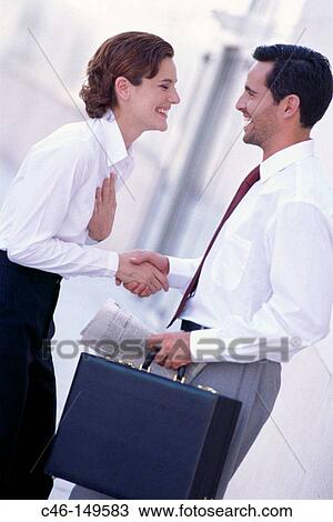 Business couple shaking hands View Large Photo Image Stock Image - Business couple shaking hands. Fotosearch