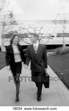 Picture - Business couple walking outdoors. Fotosearch
