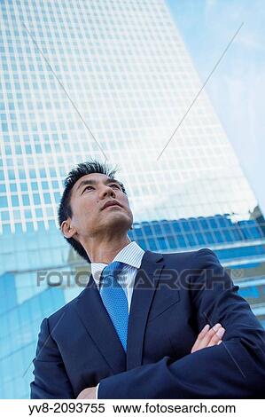 Business executive in front of skyscraper building. View Large Photo Image Stock Photography - Business executive in front of skyscraper building.. Fotosearch