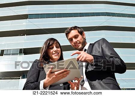 Business man and business woman with tablet. View Large Photo Image Picture - Business man and business woman with tablet.. Fotosearch