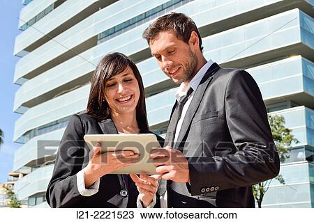 Business man and business woman with tablet. View Large Photo Image Stock Image - Business man and business woman with tablet.. Fotosearch