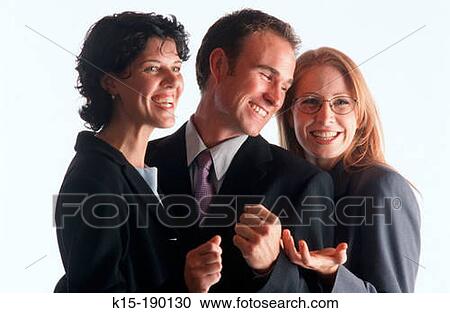 Stock Image - Business man and two female co-workers smiling with success. Fotosearch
