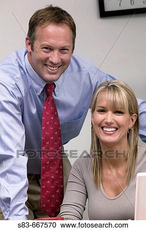 Business man and woman at desk View Large Photo Image Stock Image - Business man and woman at desk. Fotosearch