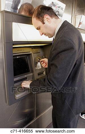 Business man at atm machine View Large Photo Image Stock Photography - Business man at atm machine. Fotosearch