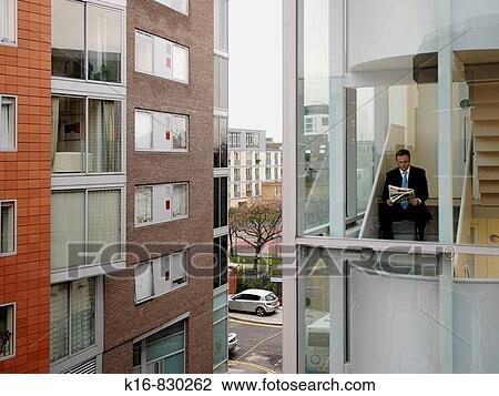 business man in isolation, reading on stairs View Large Photo Image Stock Image - business man in isolation, reading on stairs. Fotosearch