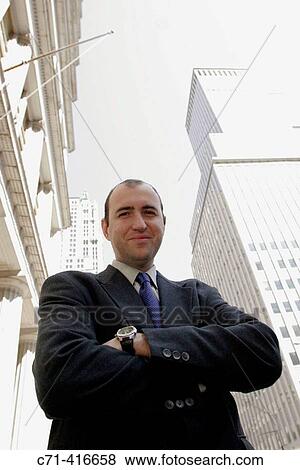 Stock Photo - Business man looking into camera on street. Fotosearch