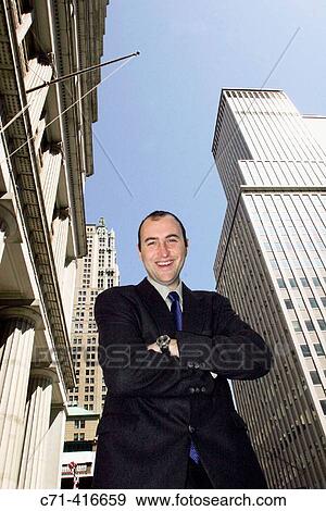 Stock Photo - Business man looking into camera on street. Fotosearch