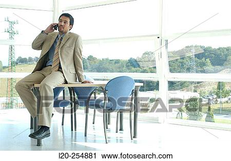Stock Image - Business man on cell phone. Fotosearch