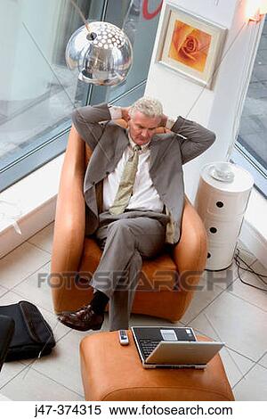 Business man sitting with laptop, concentrating on the screen View Large Photo Image Stock Photography - Business man sitting with laptop, concentrating on the screen. Fotosearch