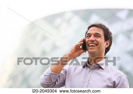 Business man talking with smartphone in business center. San Sebastian Technology Park. Donostia. Gipuzkoa. Basque Country. Spain. View Large Photo Image Picture - Business man talking with smartphone in business center. San Sebastian Technology Park. Donostia. Gipuzkoa. Basque Country. Spain.. Fotosearch