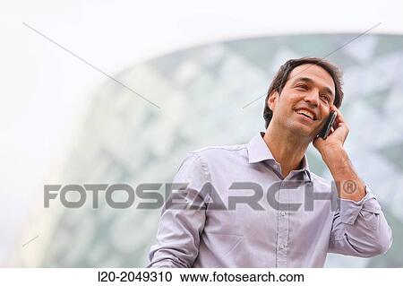 Business man talking with smartphone in business center. San Sebastian Technology Park. Donostia. Gipuzkoa. Basque Country. Spain. View Large Photo Image Stock Image - Business man talking with smartphone in business center. San Sebastian Technology Park. Donostia. Gipuzkoa. Basque Country. Spain.. Fotosearch
