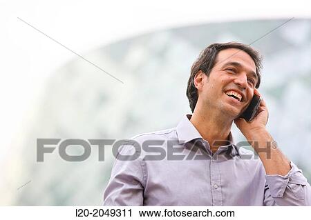 Business man talking with smartphone in business center. San Sebastian Technology Park. Donostia. Gipuzkoa. Basque Country. Spain. View Large Photo Image Stock Image - Business man talking with smartphone in business center. San Sebastian Technology Park. Donostia. Gipuzkoa. Basque Country. Spain.. Fotosearch