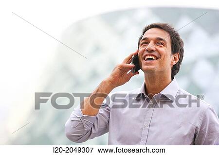 Business man talking with smartphone in business center. San Sebastian Technology Park. Donostia. Gipuzkoa. Basque Country. Spain. View Large Photo Image Stock Photo - Business man talking with smartphone in business center. San Sebastian Technology Park. Donostia. Gipuzkoa. Basque Country. Spain.. Fotosearch