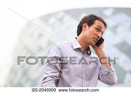 Business man talking with smartphone in business center. San Sebastian Technology Park. Donostia. Gipuzkoa. Basque Country. Spain. View Large Photo Image Stock Photo - Business man talking with smartphone in business center. San Sebastian Technology Park. Donostia. Gipuzkoa. Basque Country. Spain.. Fotosearch
