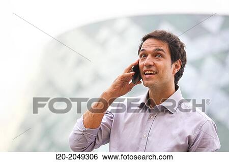 Business man talking with smartphone in business center. San Sebastian Technology Park. Donostia. Gipuzkoa. Basque Country. Spain. View Large Photo Image Stock Photograph - Business man talking with smartphone in business center. San Sebastian Technology Park. Donostia. Gipuzkoa. Basque Country. Spain.. Fotosearch