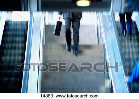 Business man walking upstairs View Large Photo Image Stock Image - Business man walking upstairs. Fotosearch