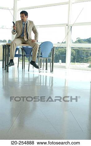 Business man with cell phone View Large Photo Image Stock Photo - Business man with cell phone. Fotosearch