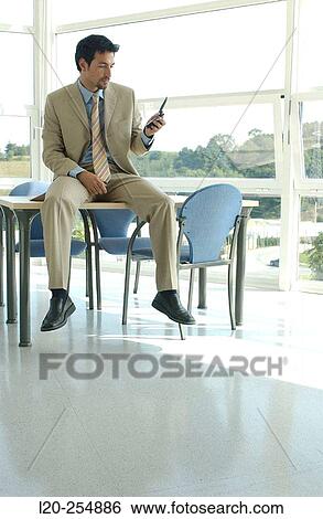Stock Photograph - Business man with cell phone. Fotosearch