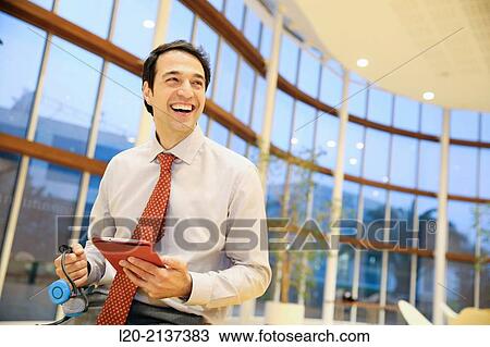 Stock Image - Business man with digital tablet. Fotosearch